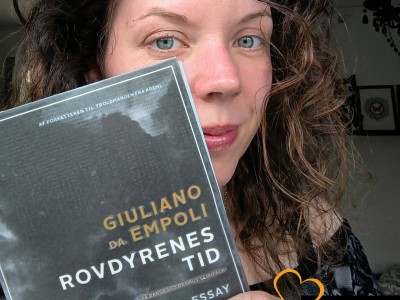 Bibliotekar står med bogen "Rovdyrenes tid"
